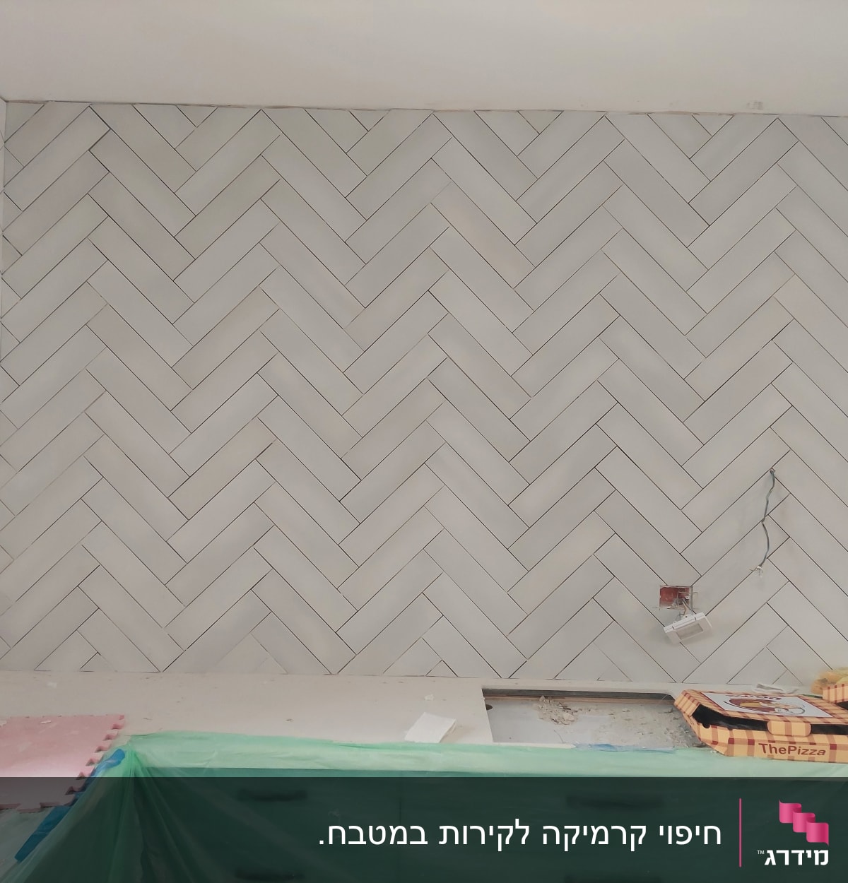 קיר אריחים בהתקנה עם שקעים חשמליים פתוחים